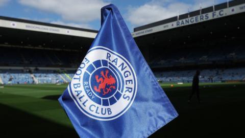 A Rangers flag on the pitch at Ibrox