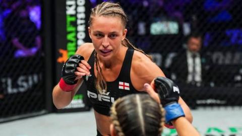 Dakota Ditcheva holds up her fists during a fight