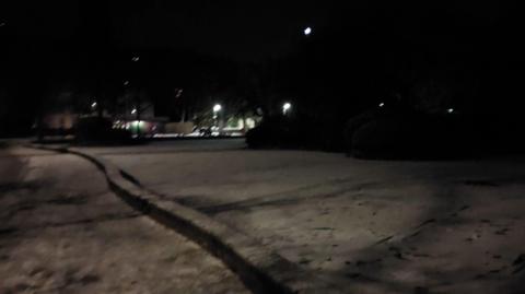 Tracks and footprints on the surface of a frozen lake at night