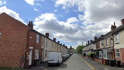 Cars parked outside terraced houses on Raby Street