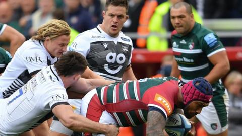 Leicester's Nemani Nadolo is tackled by Sale's Tom Curry and Tommy Taylor