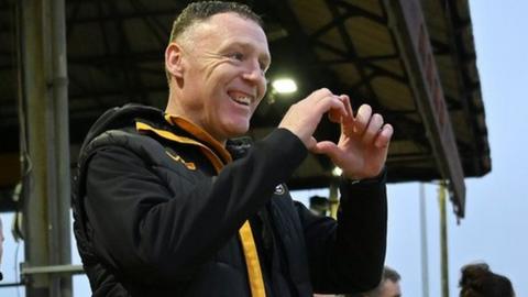 Newport County boss Graham Coughlan smiles on the touchline