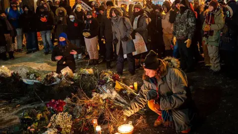People pay their respects during a candlelight vigil for Alex Pretti after he was shot and killed earlier in the day on January 24, 2026 in Minneapolis, Minnesota. Federal agents shot and killed Pretti amid a scuffle to arrest him. The Trump administration has sent a reported 3,000 federal agents into the area, with more on the way, as they make a push to arrest undocumented immigrants in the region. 