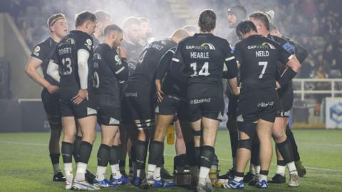 Newcastle players in a huddle during the Premiership Rugby Cup game against Bath on 7 March