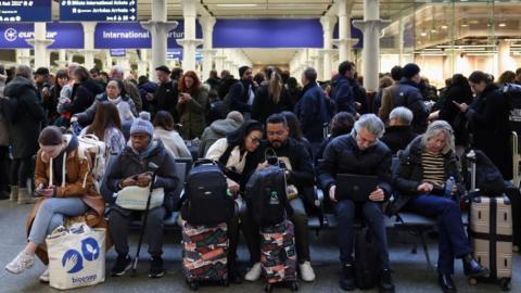 Passengers wait at the Eurostar terminal in St Pancras International Station, as an unexpected strike by French workers at Eurotunnel, the undersea link between Britain and continental Europe