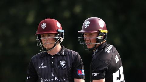 Thomas Rew (left) and older brother and Somerset captain James out in the middle against Middlesex 