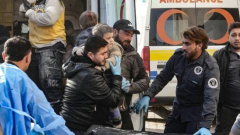 An injured child is transported to a hospital following a strike by the Syrian regime airforce, that targeted a neighbourhood in Syria's rebel-held northern city of Idlib