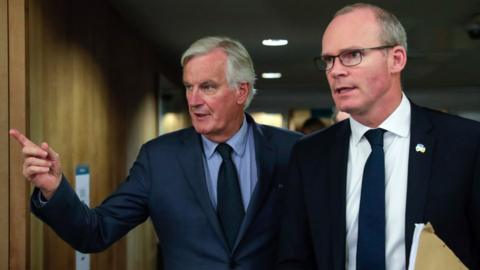 Irish Foreign Minister Simon Coveney (L) and European Union"s chief Brexit negotiator Michel Barnier