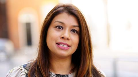 Tulip Siddiq, a woman with brown shoulder length hair wearing a neutral expression