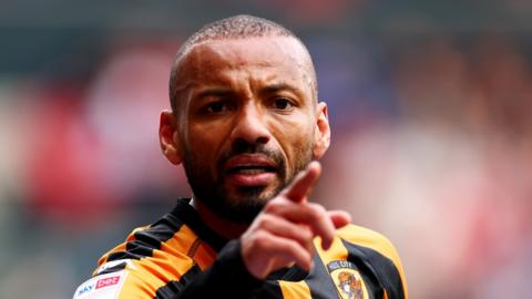 Joao Pedro pointing his finger towards another player