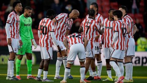Stoke City players gather in a pre-match huddle before their match between against Millwall 