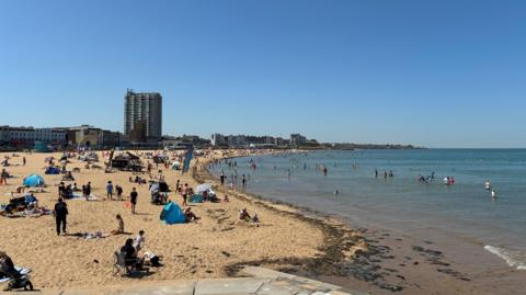 People sunbathing on the beach in Margate, Kent.