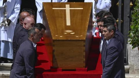 The coffin of Pope Francis is carried up the steps of the Basilica of Santa Maria Maggiore after the pontiff's funeral ceremony in St. Peter's Square