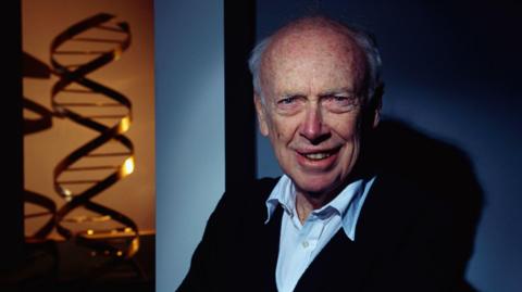 James Watson with his famous double helix model of DNA
