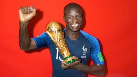N'Golo Kante holding the World Cup trophy in 2018