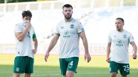 Hibernian's Joe Newell, Grant Hanley and Felix Passlack looks dejected following a 2-0 defeat during a UEFA Conference League Second Qualifying Round First Leg match between KF Malisheva and Hibernian at Fadil Vokrri Stadium, on July 23, 2026 in Pristina, Kosovo