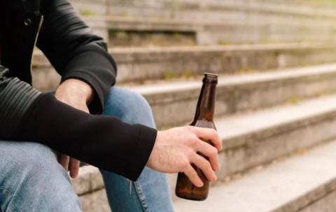 Man holding bottle on steps