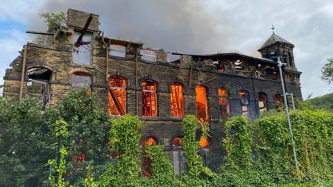 A derelict mill on fire 