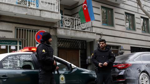 Police stand guard in front of the Azerbaijan embassy in Tehran following the attack