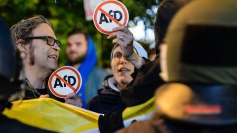 Opponents of the Alternative for Germany (AfD) protest against the result of the AfD