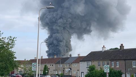 A giant column of smoke could be seen for miles on after a fire broke out at a premises in Bellshill, North Lanarkshire.