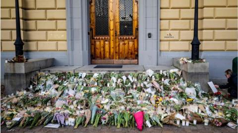 Flowers lay outside the secondary school as a memorial