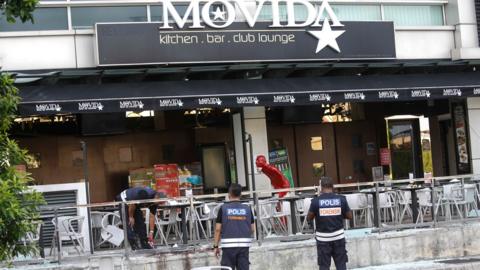 Police outside the bar, after the attack