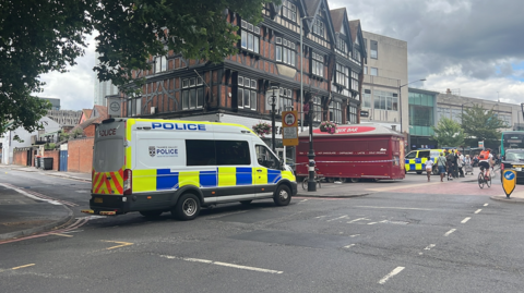 A general view picture of a police van parked up in Hosier Street, Reading, which is partly cordoned off with police tape.