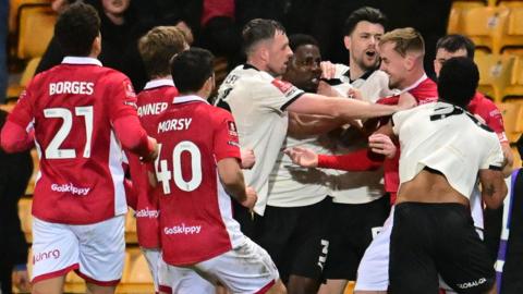 Bristol City's Mark Sykes scuffles with Port Vale players during their FA Cup tie at Vale Park