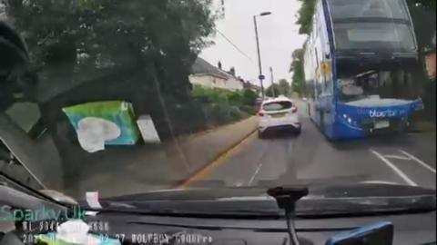 Bus appears coming towards middle of the road towards oncoming traffic