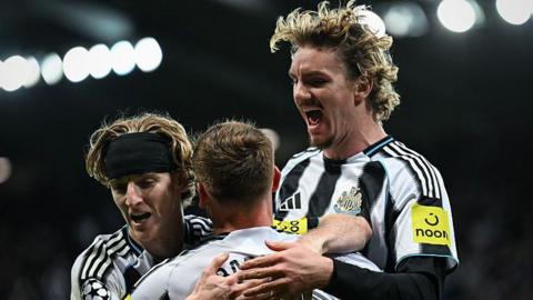 Anthony Gordon celebrates with Nick Woltemade and Harvey Barnes after the latter's goal for Newcastle United against Benfica at St James' Park on 21 October, 2025