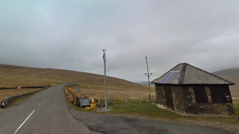 The Ben-y-Phott Road, which turns off from the Mountain Road. It is a narrow windy road across a hill and there is a small hut on the right at the turn off.