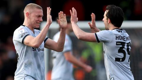 Millwall players Casper De Norre and George Honeyman high-five each other after their victory at Luton Town