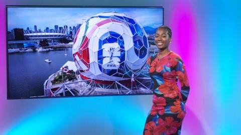 Shanequa in the studio with a giant football in the screen