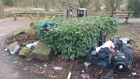 An illegal fly-tip at Memorial Park, South Moor, in Stanley, where large items such as kitchenware and sports equipment have been discarded in the park's bushes. It is an eye-sore as the rubbish has been left in the decorative bushes. 