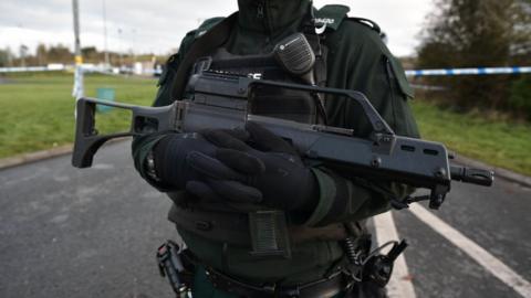 A police officer carrying a gun in Northern Ireland