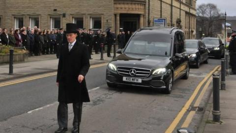 A guard of honour ahead of Peter Lawson's funeral
