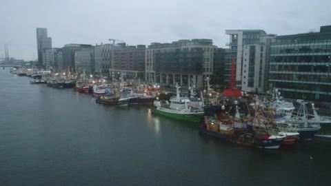 A flotilla of fishing trawlers travelled up the River Liffey in convoy