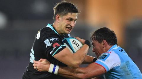 Max Nagy of Ospreys is tackled by Henco Venter of Glasgow