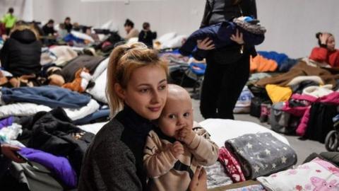 A mother and baby in a shelter for refugees near Przemysl, Poland