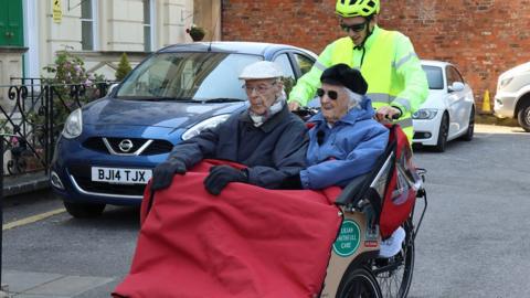 Care home residents in front of a bike