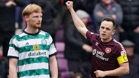 Celtic defender Liam Scales watches on as Hearts' Lawrence Shankland celebrates