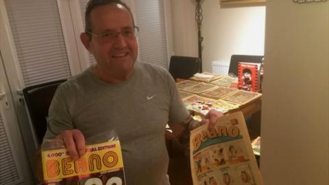 Paul Cooper with two editions of The Beano