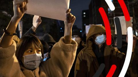 A demonstrator holds up a blank sheet of paper