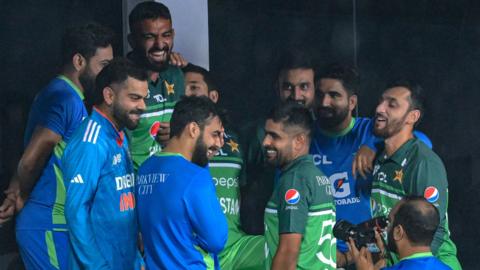 India and Pakistan players share a joke after their Asia Cup game is abandoned because of rain