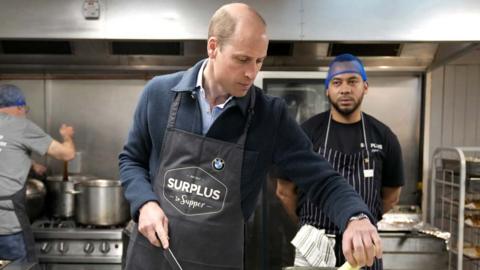 The Prince of Wales cuts celery as he helps to make a bolognase sauce during a visit to Surplus to Supper, a surplus food redistribution charity, at the charity's headquarters based in Sunbury Cricket Club, in Surrey on 18 April 2024