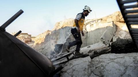 A member of Syria's White Helmets first responders at the wreckage of one of their centres which was destroyed by government bombing, 6 September 2018