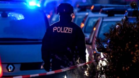 Police officer stands guard at a crime scene near a synagogue after a shooting in Halle, Germany