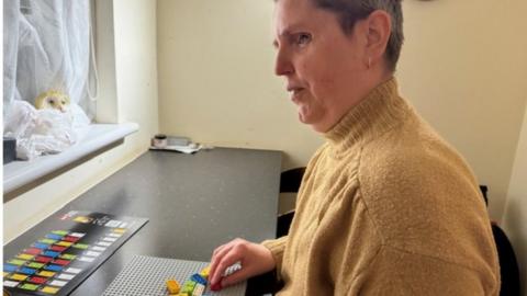 Jackie Brown playing with lego bricks