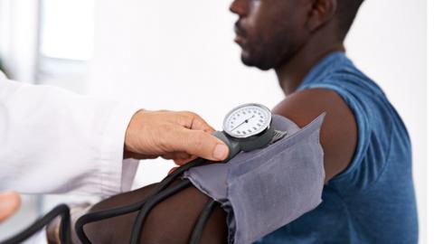 young black man having blood pressure taken